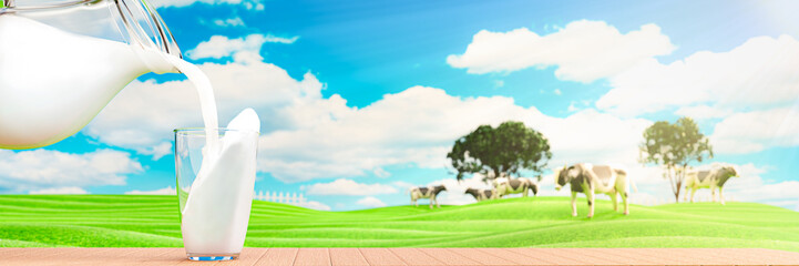 Obraz na płótnie Canvas Pour fresh milk from the jug into a clear glass placed on a wooden plank floor. Bright green grassland cows are walking freely and enjoying eating grass. Clear blue sky with white clouds. 3D rendering