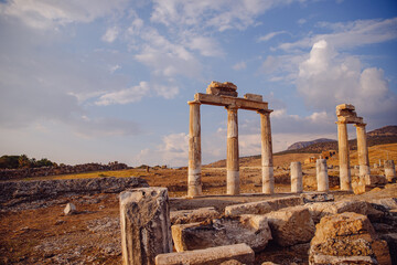 Ancient ruins of columns Amphitheater in Hierapolis city in Pamukkale Turkey sunset