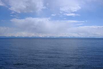 View of the snow-capped mountains of the eastern shore of Lake Baikal, May 2022