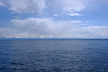 View of the snow-capped mountains of the eastern shore of Lake Baikal, May 2022