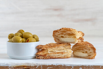 Cheese Bourekas on white wooden background. Israeli Savory Pastry.