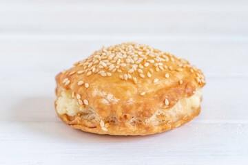 Israeli Savory Cheese Pastry Bourekas on white wooden background.