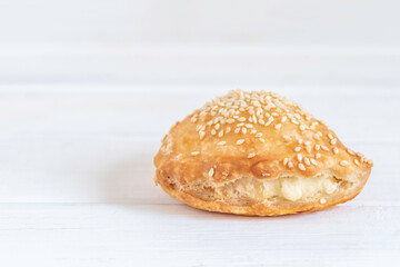 Israeli Savory Cheese Pastry Bourekas on white wooden background.