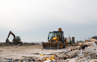 Excavator performs excavation work on contraction site at the beach