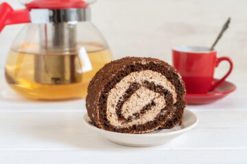 Cappuccino Roulade for tea drinking on white wooden background.