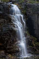 Fototapeta premium view of waterfall pouring through cliffs