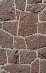 Pattern of ancient bricks and stones at old middle age fortress wall, as a background, closeup, details.