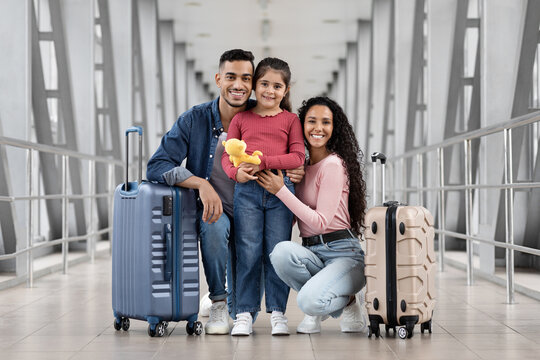 Happy Arab Mother, Father And Little Daughter Posing At Airport Together