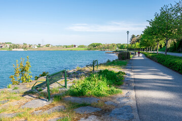 Benches along a footpath at Hafrsfjord bay coast near the Sword in Rock monument, Stavanger, Norway, May 2018