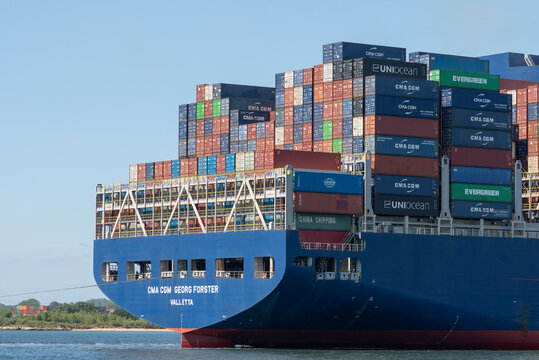Southampton, England, UK. 2022. Stern of a container ship with colourful cargo of containers stacked on deck.