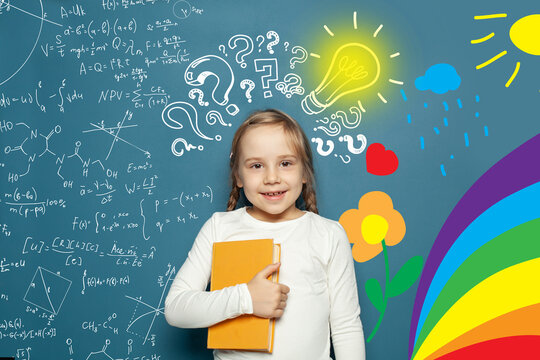 Idea! Smart small girl kid student with lightbulb on blackboard