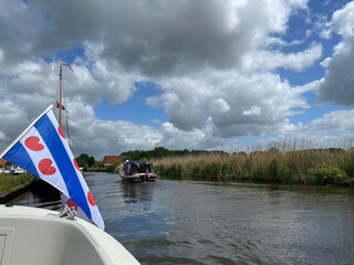 Frisian flag at a boat on a canal