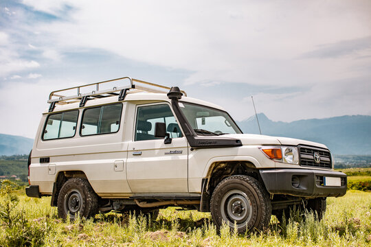 Toyota Land Cruiser HZJ78 Hardtop parked on field in front of Accursed Mountain Range in Gjakov&euml;, Kosovo