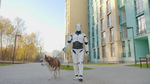 White humanoid robot walking husky dog with leash on residential complex area. Smart machine replacing human labor. Future concept of artificial intelligence.