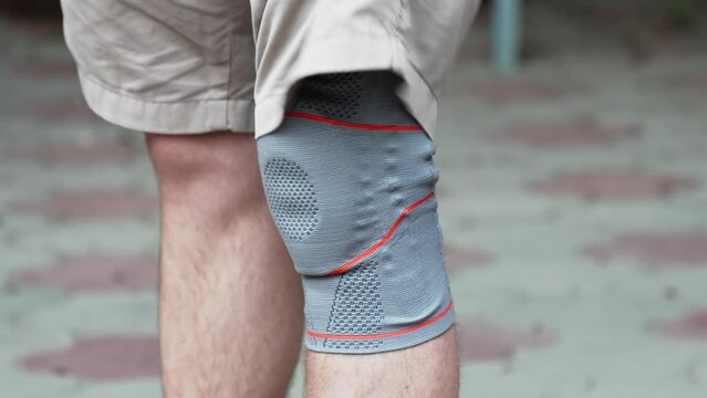 Knee pad on a man's leg. knee bandage. Fixing Orthosis.