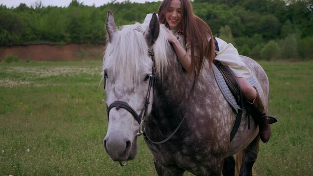The girl is lying on a horse. Woman riding a horse. Hugs the horse. Ukraine