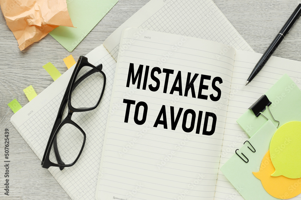 Poster mistakes to avoid . open notepad notebook with text near glasses. bright stickers
