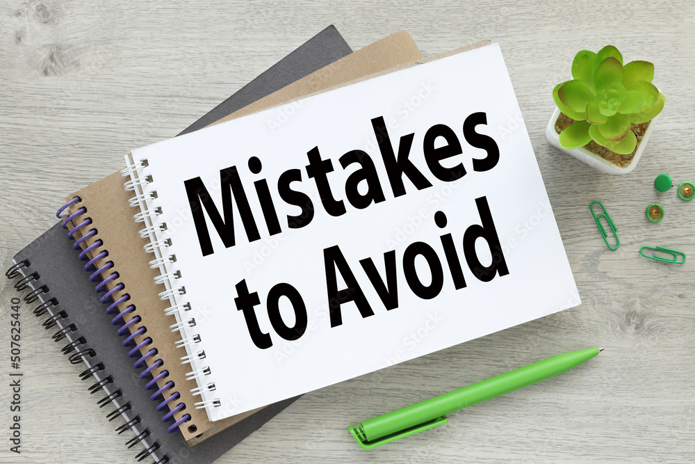 Poster mistakes to avoid several notebooks on the table. text on the page of the notebook. potted plant and
