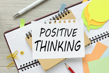 Think positive, text on a notepad page. bright stickers