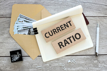 CURRENT RATIO. text on an open notebook on an envelope with money, business and financial concept....