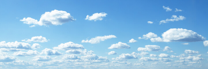 Obraz na płótnie Canvas blue sky background banner, fluffy clouds on a summer day in sunlight