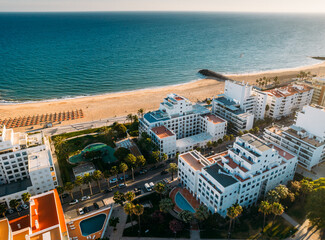 Aerial view of beach, boardwalk and buildings in Quarteira, Algarve, Portugal © Alexandre Rotenberg