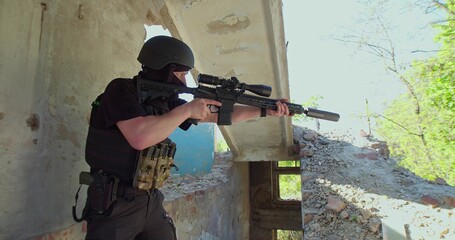 Fototapeta premium A sniper from a destroyed house guards the street