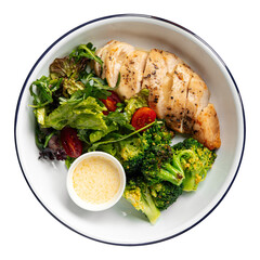 Isolated portion of baked chicken breast with salad