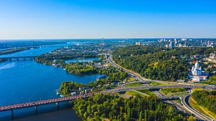 Aerial view to the  Beautiful landscape city Kiev with a Dnepr river in sunny day. Top view to the urban landscape. Panorama of a big european city.