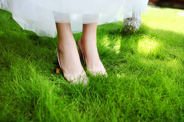 Bride's wedding shoes on green grass