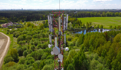 Aerial view of the tower of mobile communications, telecommunications and the 5g Internet. An iron head with locators and antennas. 25 May 2022, Minsk, Belarus