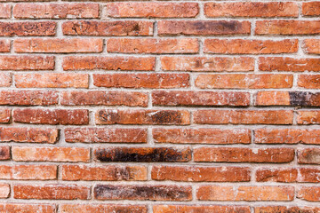 Old red brick wall background texture close up
