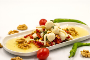 Specially prepared breakfast cheese. A special cheese plate prepared with olive oil, vegetables, walnuts and cheeses. close up