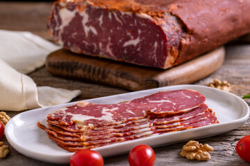 Turkish pastrami. Bacon made from ribeye meat. Beef pastrami sliced Pastirma or Turkish pastrami. Close-up.