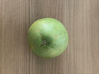 Top view of pomelo isolated on wooden table.