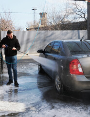 
Street car wash self-service.
Washing in the open air.
A man washes a vehicle with shampoo under...