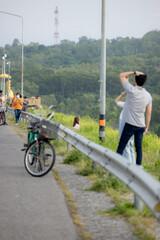 people riding bicycles, playing and exercising on vacation On the road and see the beautiful nature Thailand Dates 28-5-2022