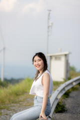 cute girl standing and playing with beautiful nature with clear sky on vacation They stood and took pictures happily.