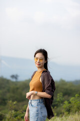 cute girl standing and playing with beautiful nature with clear sky on vacation They stood and took pictures happily.