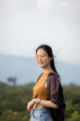 cute girl standing and playing with beautiful nature with clear sky on vacation They stood and took pictures happily.
