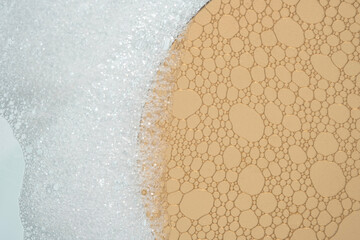 Fluffy white foam with orange glass that shows the structure of the product.