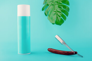 vintage razor, foam and big green leaf on meant background. Space for text.