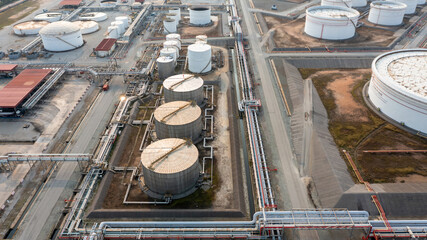 Aerial view fuel reservoirs petroleum industrial zone and metal exhaust pipes oil refinery factory,...