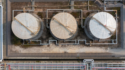 Aerial view fuel reservoirs petroleum industrial zone and metal exhaust pipes oil refinery factory,...