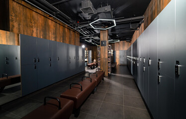 Modern dressing room in gym club. Fitness club dark locker room.