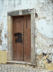 Colorful traditional wooden door in old facade, typical for Portugal 
