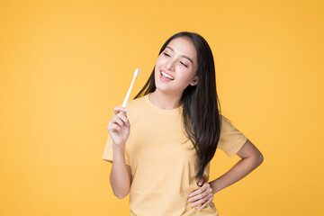 Portrait of Happy Asian female brushing her Teeth. Young Asian Woman brushing her teeth with clean...