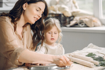 Portrait of mother and little girl shaping clay together
