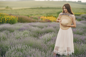 Woman without bra standing in a lavender field