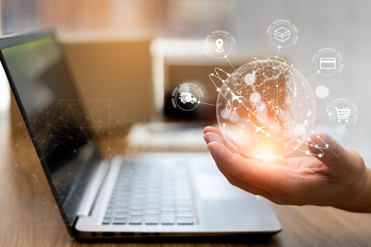 Transport process on virtual screen concept: Close up hand a man show global network connect to  customer in shopping online on wood table and parcel box in blur background